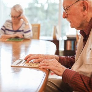 two elderly people playing bingo