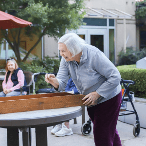 senior woman playing games outside with friend