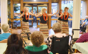 group of dancers performing for seniors at a care home