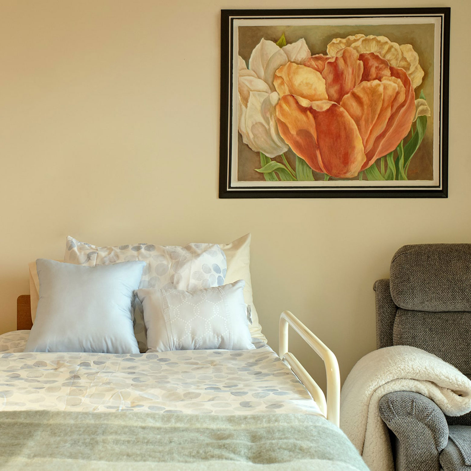 beautiful painting of flowers hung above bed