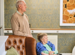 elderly man and woman looking across a room