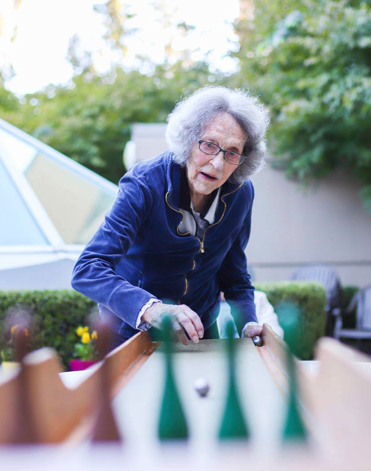 woman playing table bowling outside