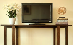 television and flowers on table