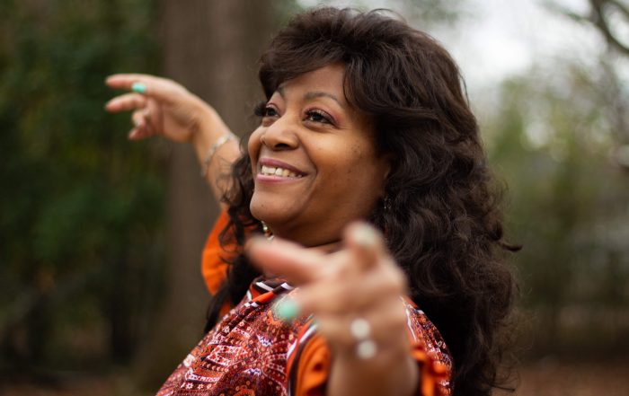 older lady smiling and dancing with good mental health