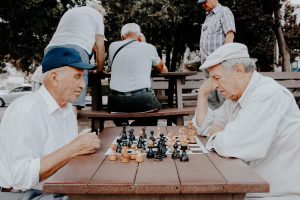 two senior men playing chess representing retirement homes in North Vancouver