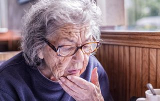 woman having a senior moment looking at a menu confused