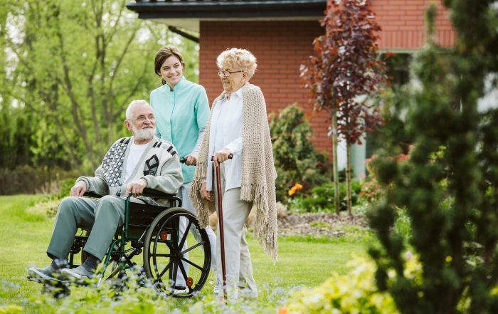 Senior man on the wheelchair in the garden of professional nursing home