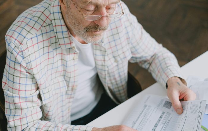 senior man How Much is Old Age Security in Canada form paperwork
